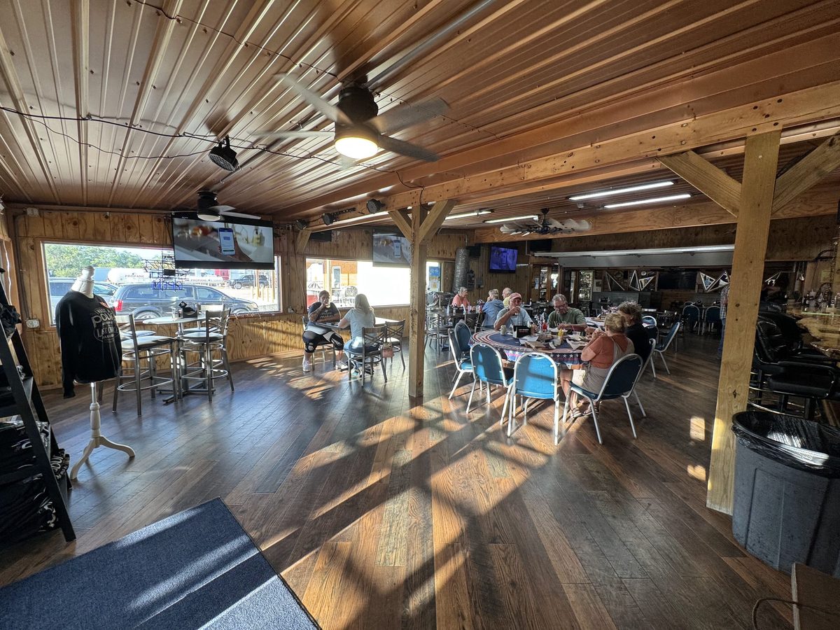 Inside Last Chance Bar & Grill, with wood floors and an open dining room