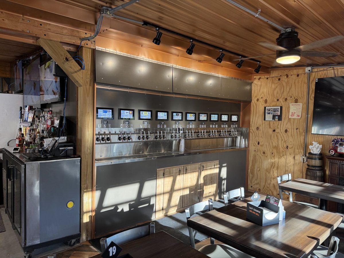 The self-pour tap wall and bar at Last Chance Bar & Grill